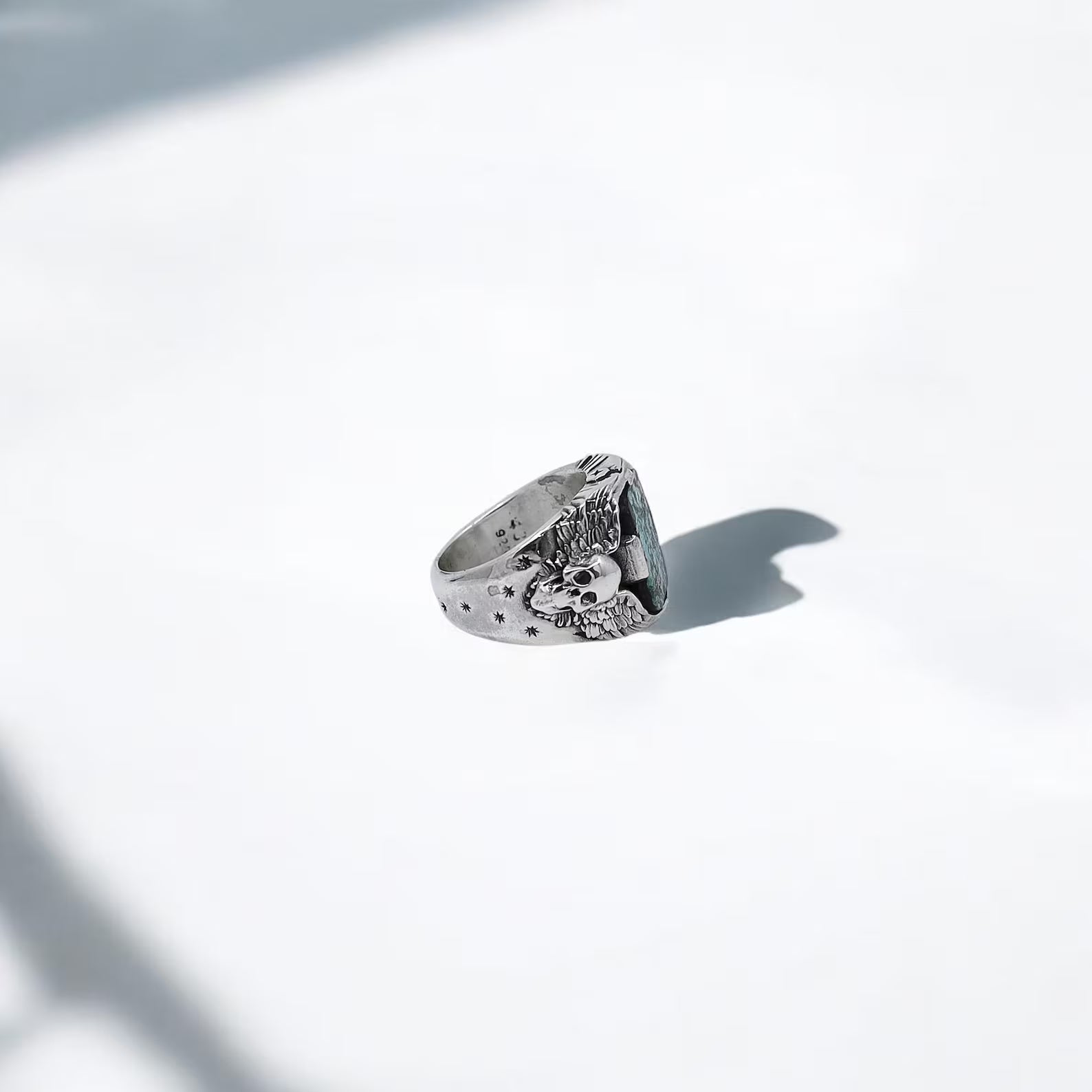 A handcrafted turquoise skull ring that embodies gothic flair and biker toughness. With twin silver skulls flanking a rough turquoise gem, this sterling silver ring is the perfect gift for any man who rides, rebels, or walks his own path. Whether you're shopping for a birthday, a special occasion, or just a gift for a bold soul, this piece offers rugged elegance and lasting symbolism.