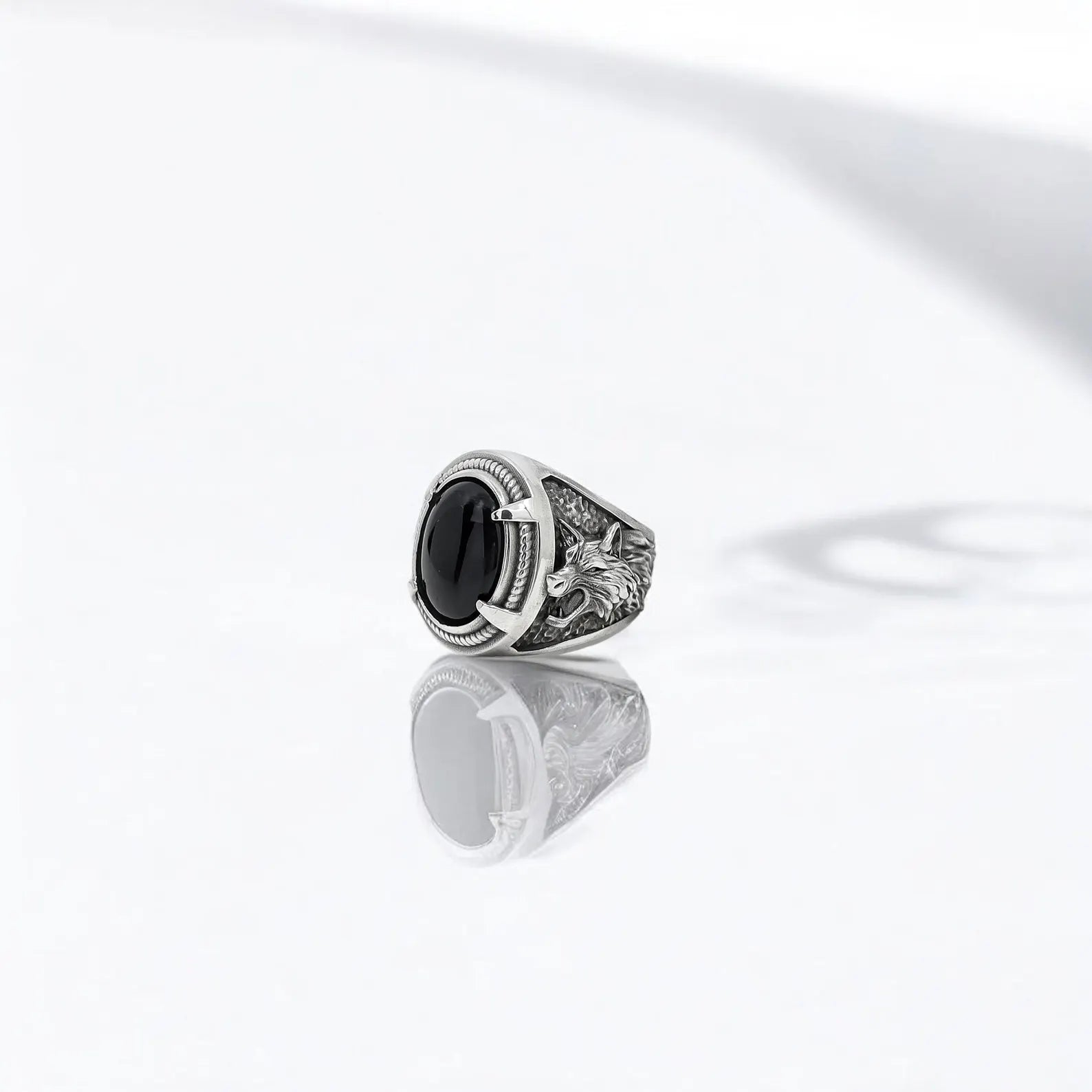 Silver warrior ring designed for men who seek jewelry that tells a story. Featuring a black onyx gemstone and a pair of engraved wolf heads, this artisan ring captures the essence of Viking strength and mystical protection. The detailed band and dark gemstone offer a unique balance of masculinity and mysticism, perfect for those with bold, spiritual taste.