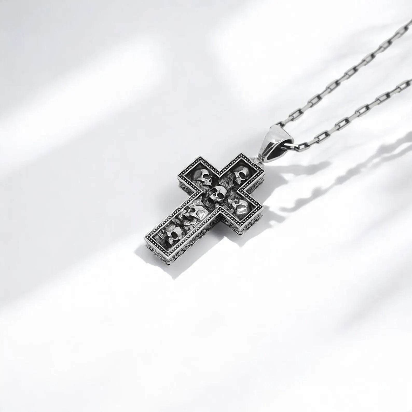 Sterling silver gothic skull necklace in cross shape, designed for bikers, rockers, and gothic jewelry fans. Heavy and durable with a unique edgy aesthetic, perfect for personal wear or as a striking gift.