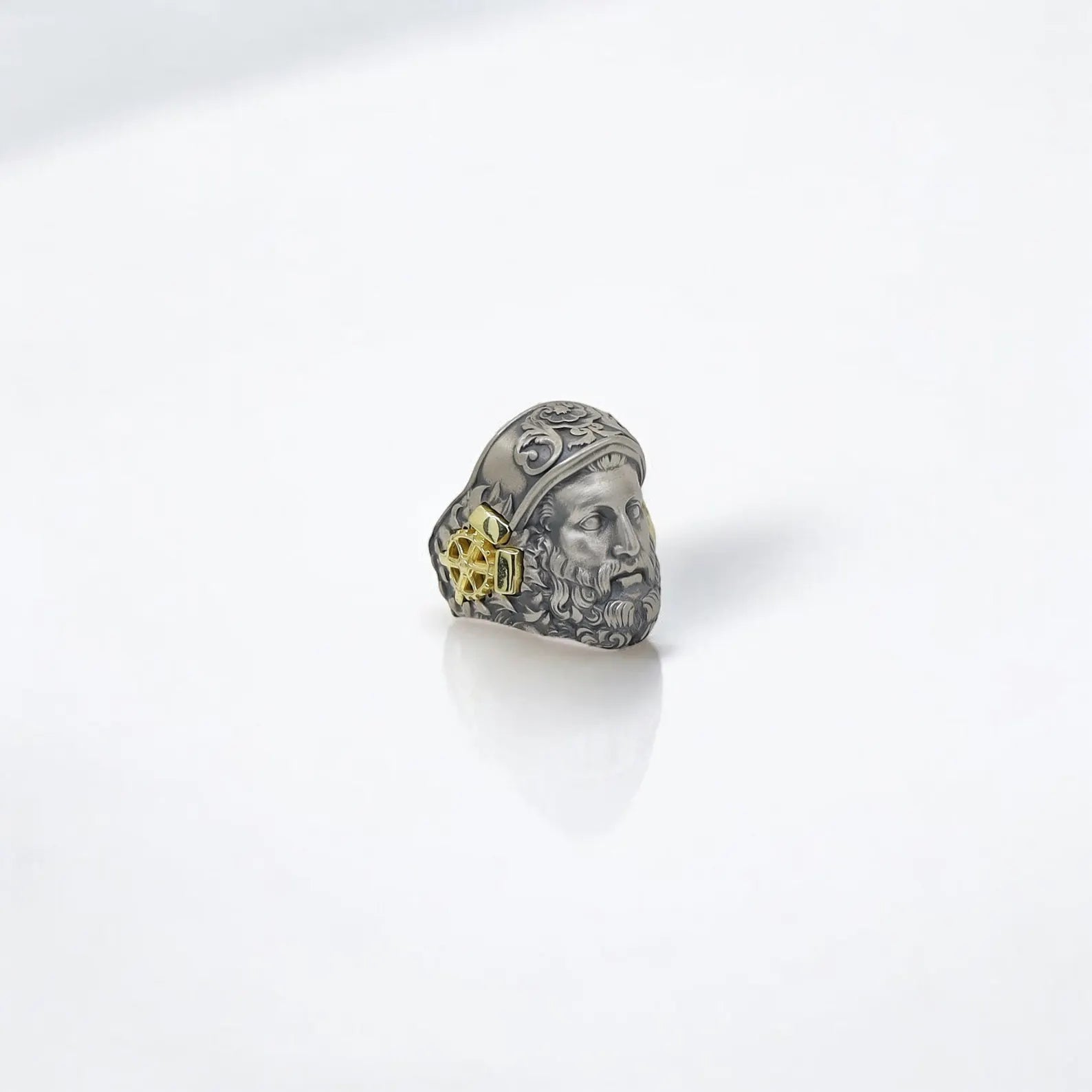 A museum-worthy piece of wearable mythology, this Hephaestus Greek god ring is made from oxidized 925K sterling silver and finished with eye-catching 14k gold-plated geometric motifs. The detailed sculpted face of Hephaestus—the divine artisan of Olympus—exudes both wisdom and masculine power. Perfect for men who appreciate handcrafted jewelry with meaning, this ring makes a memorable gift for mythology enthusiasts, historians, or those who live boldly and walk their own heroic path.