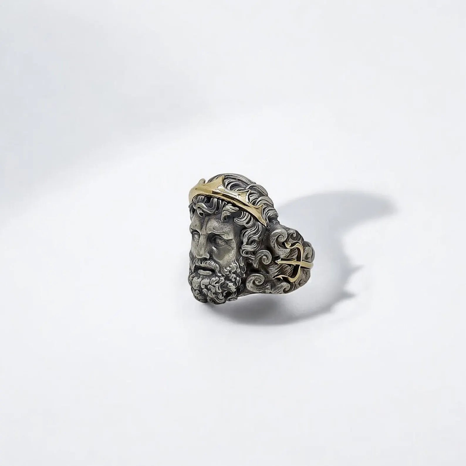 Inspired by the might and mystique of ancient Greek mythology, this Poseidon ring for men is a bold declaration of inner power and refined taste. Crafted with 925 silver and touched with 14K gold, the ring showcases extraordinary workmanship and balance between rugged strength and mythological beauty.