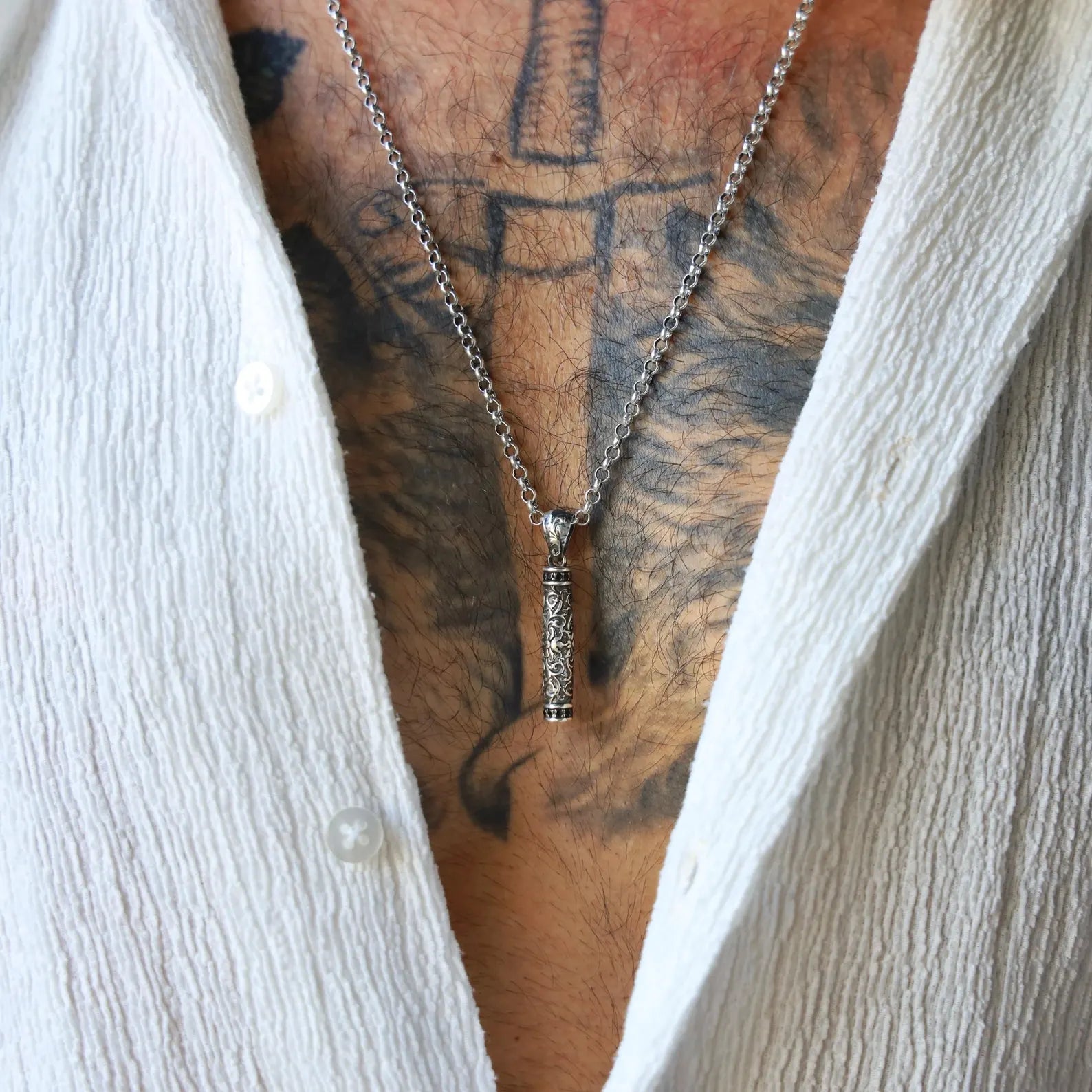 Unique gothic necklace with oxidized floral details carved into a cylindrical sterling silver pendant. Designed for both men and women who appreciate statement jewelry with antique motifs. Great for Google product search visibility and Shopify’s handmade jewelry catalog.