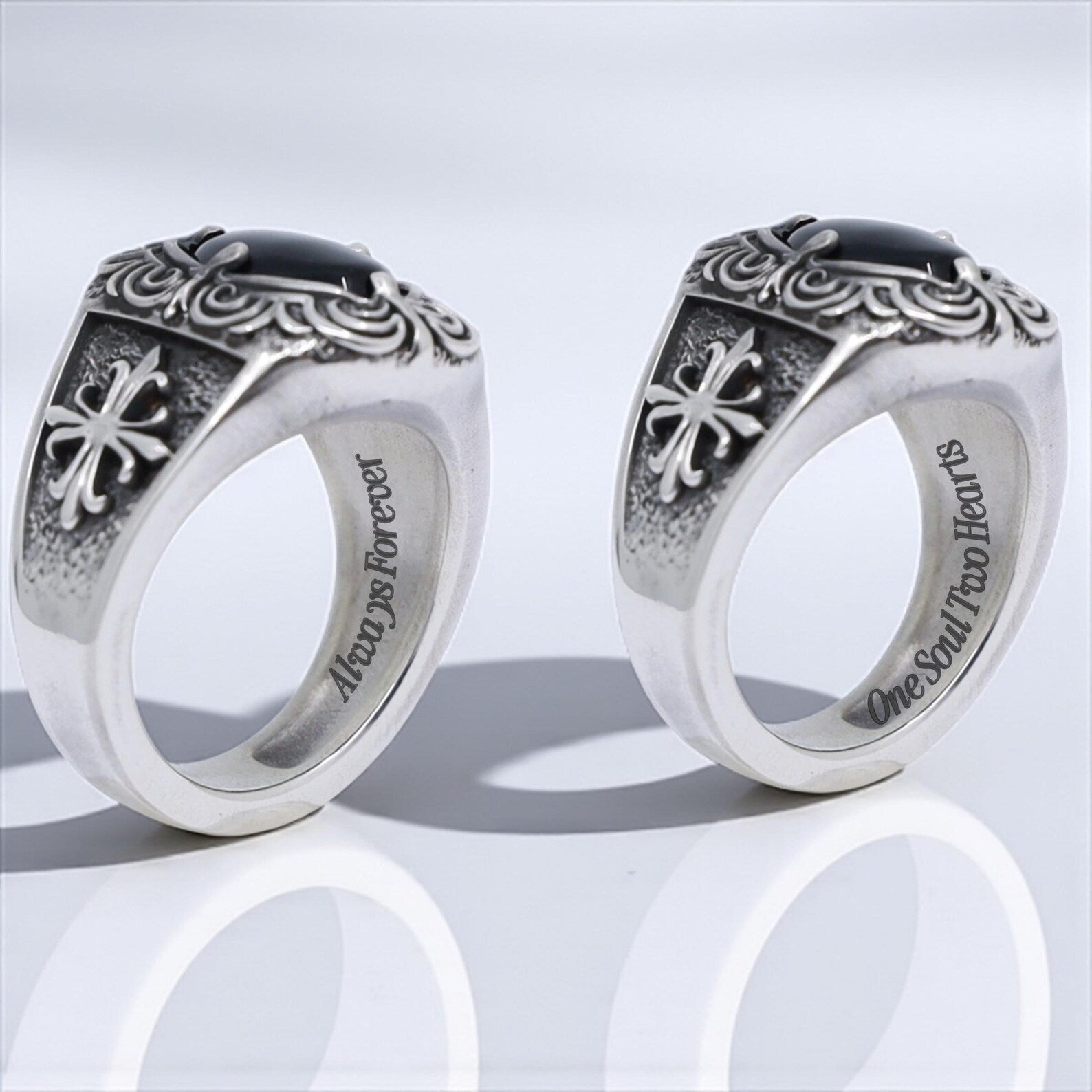 Artistic photograph of a vintage-inspired men's silver ring with a deep black onyx gemstone centerpiece, enriched with handcrafted gothic engravings and cross motifs on the band—perfect for gothic fashion lovers, biker aesthetics, or those looking for a unique, meaningful handmade gift.