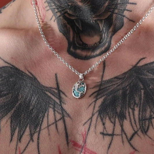 925 sterling silver pendant necklace showcasing a stunning blue turquoise inlay. The intricate handcrafted design reflects a world pattern motif, offering a unique and meaningful accessory that complements both casual and formal looks.