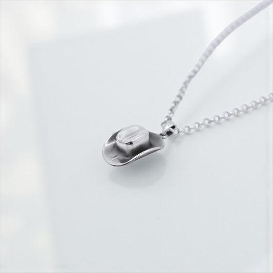 Western-themed jewelry piece with a finely crafted sterling silver cowboy hat pendant, designed for those who appreciate minimalist country-inspired fashion with vintage vibes.