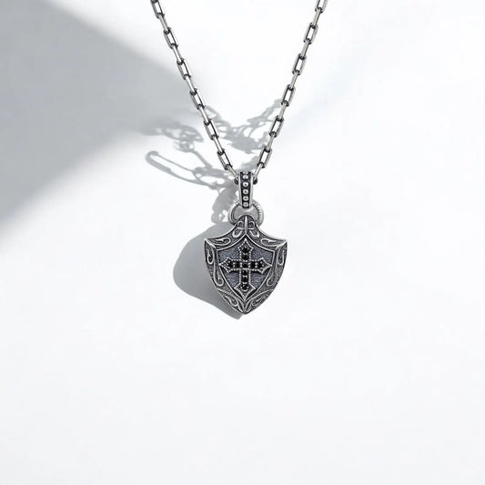Handcrafted sterling silver shield necklace featuring a detailed Gothic cross design inspired by medieval armor and Knights Templar symbolism. This antique-style pendant is perfect for those who love historical jewelry and want to showcase strength and timeless style in their accessories.