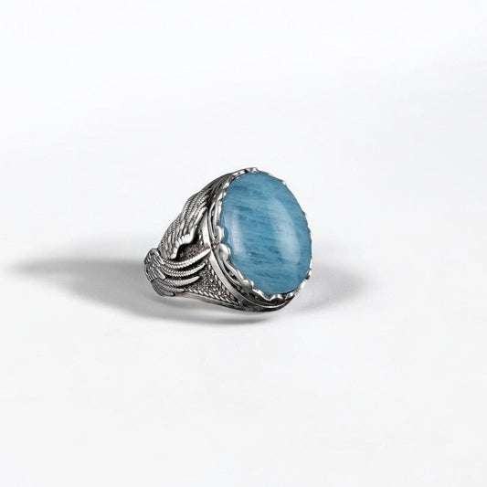 A handcrafted 925 sterling silver ring featuring a large, natural aquamarine gemstone set within an intricate dragon claw design, symbolizing strength, wisdom, and protection. This gothic-style statement ring blends nature-inspired elements with mystical symbolism, making it a powerful and meaningful gift for men who appreciate bold, artisan-crafted jewelry.