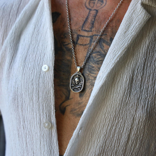 Handcrafted Sterling Silver Gothic Skull Pendant Necklace for Men featuring a detailed crown and crossbones motif, designed to embody dark symbolism and rebellious spirit with a bold polished finish.