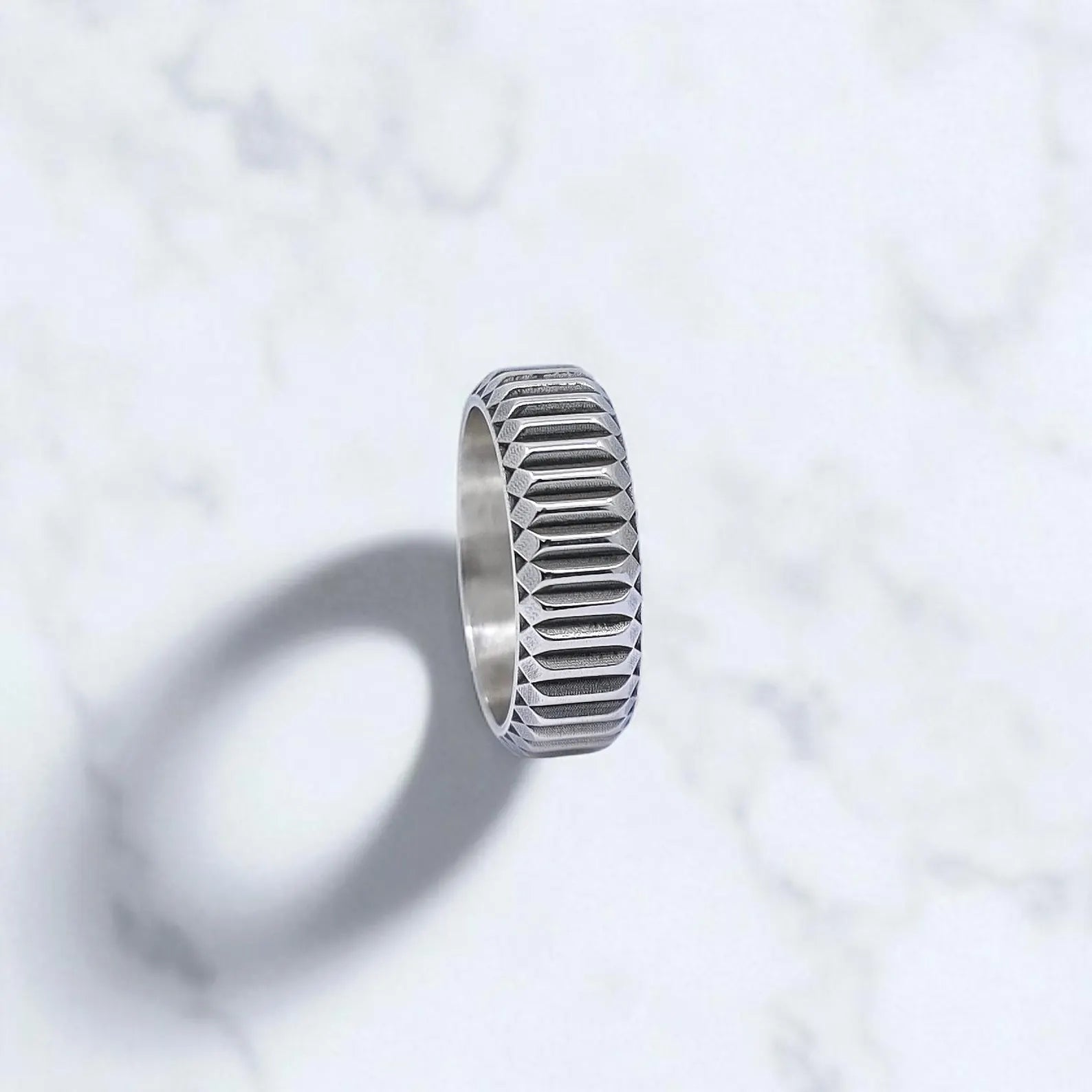 Unisex minimalist sterling silver ring with a textured outer surface and clean interior finish, handcrafted for durability and comfort. The ring’s sleek, symmetrical design is ideal for both casual and formal wear, offering a sophisticated touch for style-conscious individuals looking for unique handmade jewelry.