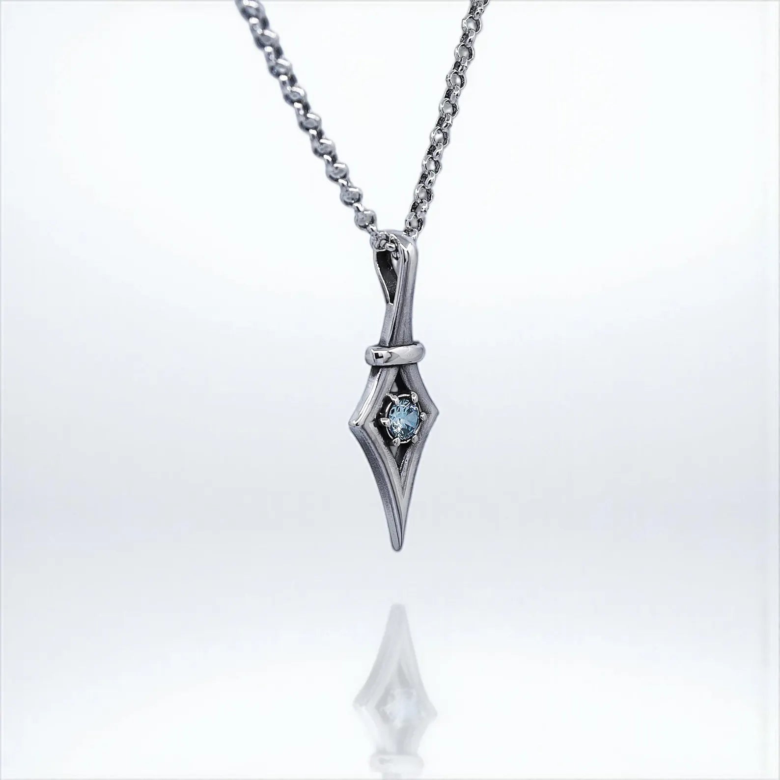 Sterling silver aquamarine pendant necklace in a gothic-inspired design. This handmade piece combines minimalist elegance with alternative fashion, making it perfect for gothic style lovers. A symbolic March birthstone gift for her, ideal for birthdays, holidays, or as a meaningful everyday necklace.
