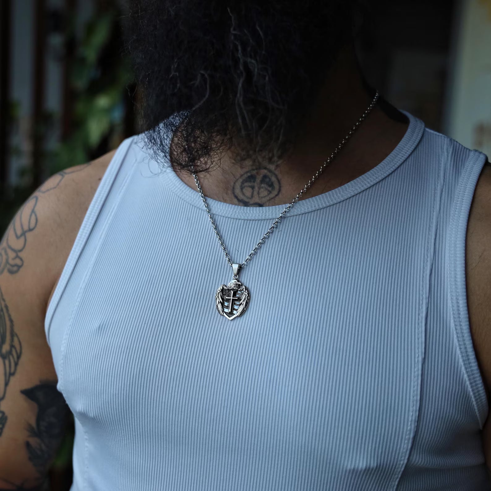 Overhead view of the handcrafted sterling silver eagle cross pendant highlighting its intricate details and smooth polished surface. Measuring 35mm in diameter and 23mm in height, this pendant offers a substantial and symbolic presence on the chest. A standout patriotic necklace for men who embrace their roots and wear their values with pride and style.