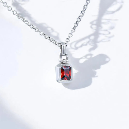 This handcrafted sterling silver necklace features a radiant emerald-cut lab ruby gemstone, symbolizing passion, love, and vitality. Designed with exceptional detail and a polished finish, this elegant unisex pendant is ideal for those who appreciate luxurious jewelry with meaning. Whether given as a birthday, anniversary, or milestone gift, it offers a timeless charm that blends sophistication with deep emotional value. The rich red stone captures attention effortlessly
