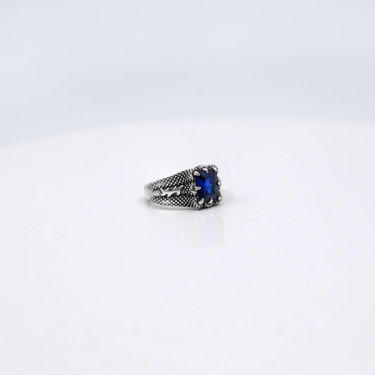 Close-up of this stunning sterling silver sapphire ring, showcasing the exquisite emerald cut zircon stone that radiates luxury and sophistication. This handcrafted minimalist ring is a versatile piece, ideal for men and women who appreciate refined gemstone jewelry with a modern twist. Elevate your style and celebrate life’s milestones with this timeless birthstone ring that blends elegance and meaning.