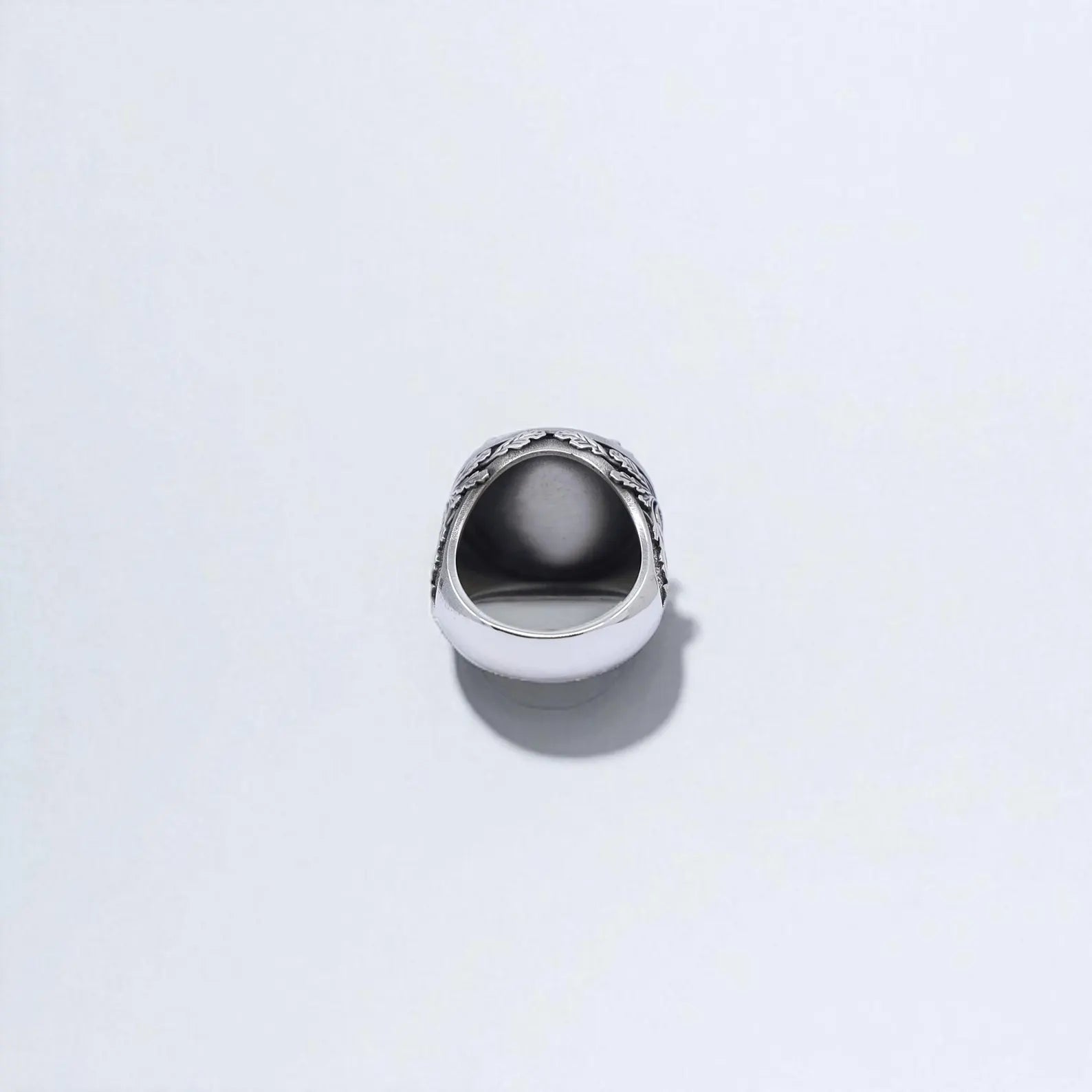 Zoomed view showing the ring’s curved band and engraved motifs that wrap around the sides. The symbolism of the stag and cross offers a connection to nature, spiritual protection, and courage — ideal for a thoughtful keepsake.