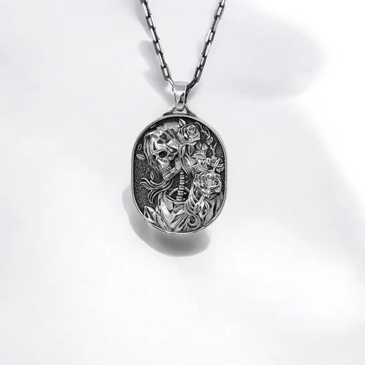 Sterling silver Gothic Skull Cameo Necklace featuring a skeleton portrait surrounded by intricate floral details. This Day of the Dead inspired pendant blends romantic elegance with dark symbolism, making it a perfect piece for lovers of gothic fashion, alternative jewelry, and handcrafted statement accessories.