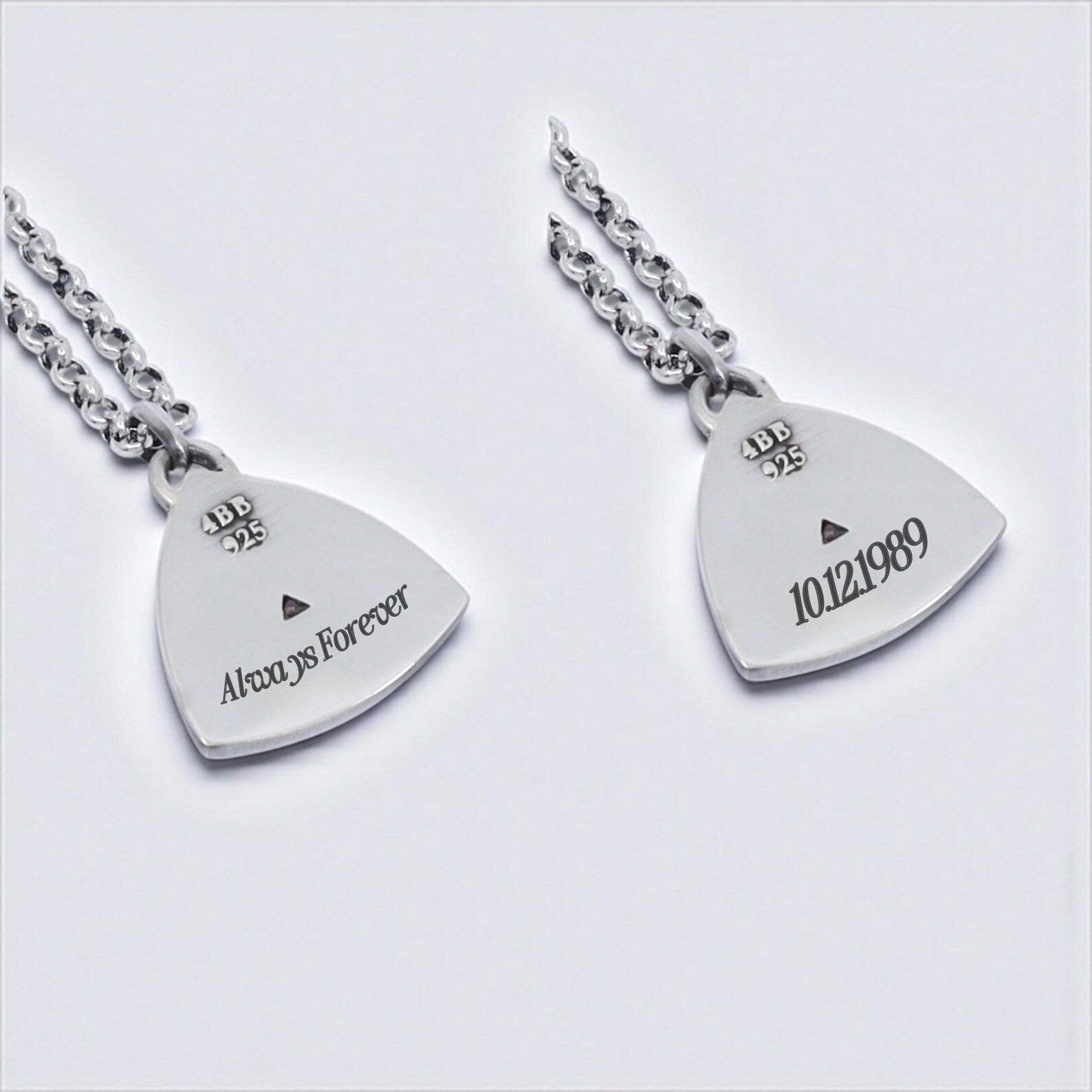 A uniquely designed geometric necklace showcasing a triangular ruby-like stone set in solid 925 silver, suspended on a polished chain, capturing the essence of handcrafted elegance and timeless gift-worthy design.