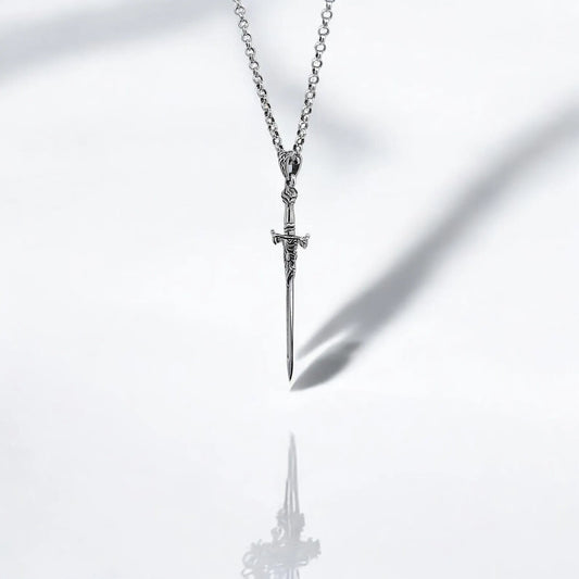 Sterling silver sword pendant handcrafted from 925K silver, showcasing detailed engravings along the hilt and blade. This warrior-inspired gothic necklace blends medieval elegance with symbolic strength, making it a powerful piece of jewelry for those who appreciate artisanal design and mythological storytelling in their fashion accessories.