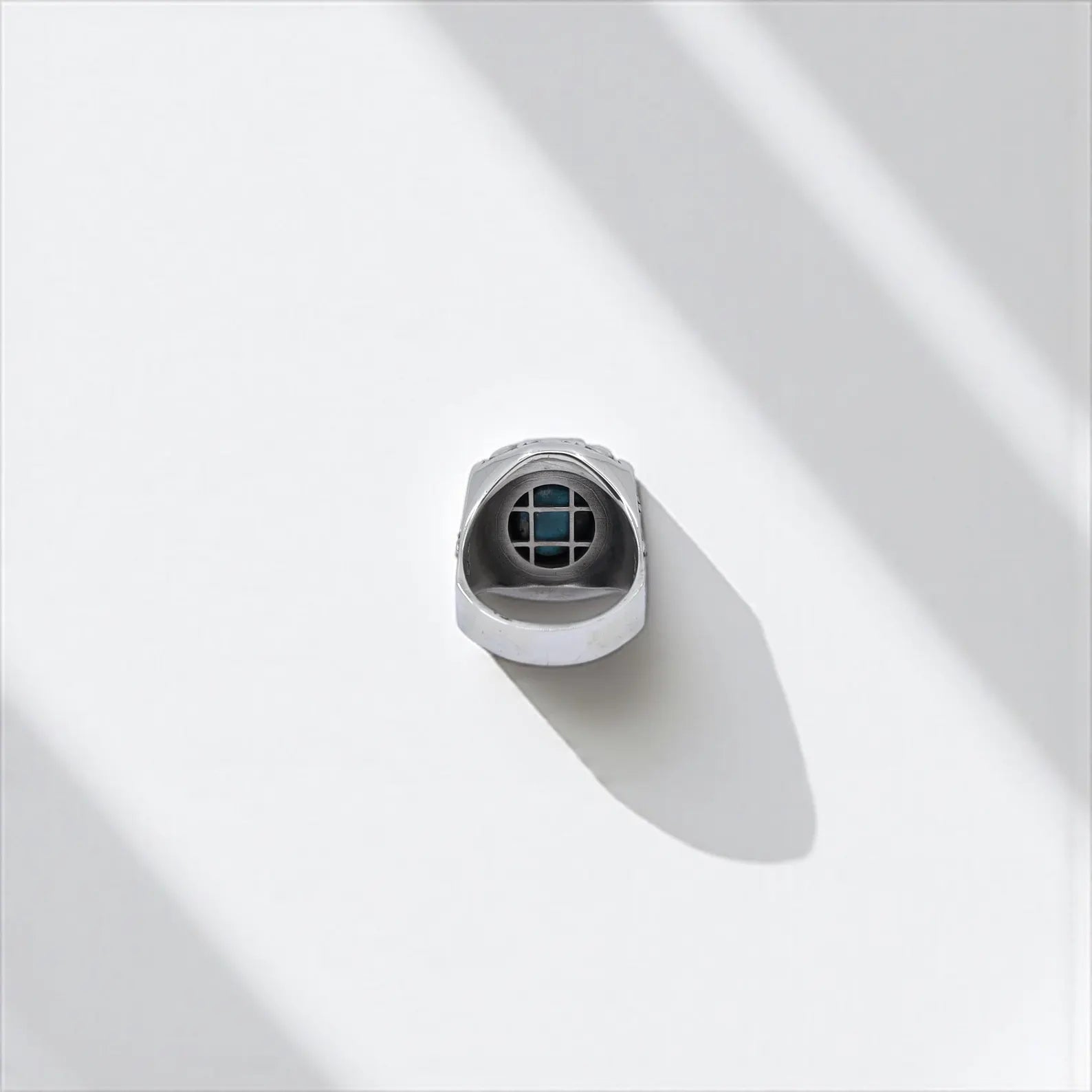 Artistic product image of a bold sterling silver ring for men, with a natural turquoise stone and deep gothic motifs inspired by freedom, rebellion, and vintage tattoo art.