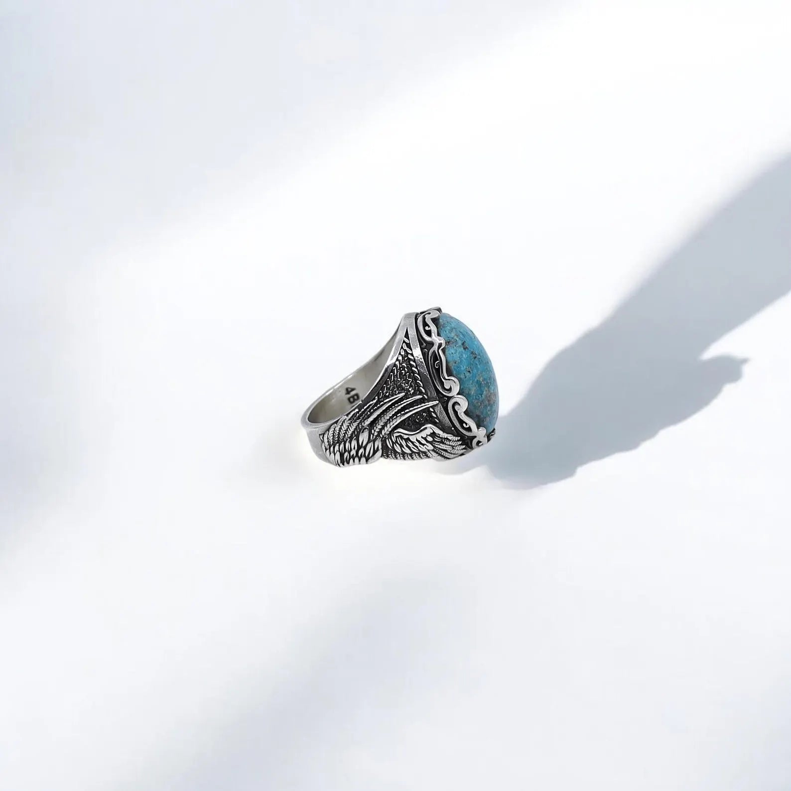 Make a lasting impression with this 925K silver turquoise wing ring that merges rustic elegance with handcrafted depth. The detailed engraving, combined with a bold natural turquoise gemstone, creates a timeless masculine piece that tells a story of resilience and freedom. A unique and symbolic gift for men who appreciate artistry, earthy power, and the calming essence of natural stones.