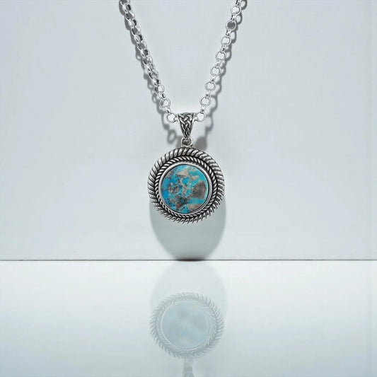 Close-up view of the Southwestern Turquoise Pendant Necklace handcrafted in 925 sterling silver. The vibrant natural turquoise gemstone sits in a bold rope-edge frame, highlighting the rustic Western aesthetic. Perfect for men who love unique, meaningful, artisan gemstone jewelry. A stunning statement necklace and an ideal gift for birthdays, anniversaries, Christmas, or Valentine’s Day.
