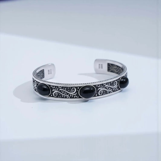 Handcrafted black onyx biker cuff bracelet made from durable 925 sterling silver, featuring bold vintage engravings and three natural onyx stones, designed for men who appreciate unique, masculine, statement jewelry.