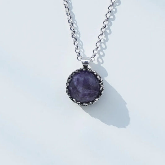 Handcrafted 925 sterling silver amethyst pendant necklace featuring a deep purple natural gemstone in a vintage-inspired baroque leaf design, shown in high-detail close-up with oxidized and hand-polished finish, elegant unisex artisan jewelry.