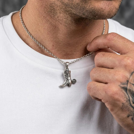 Detailed cowboy boot necklace pendant featuring vintage western craftsmanship and oxidized sterling silver finish.