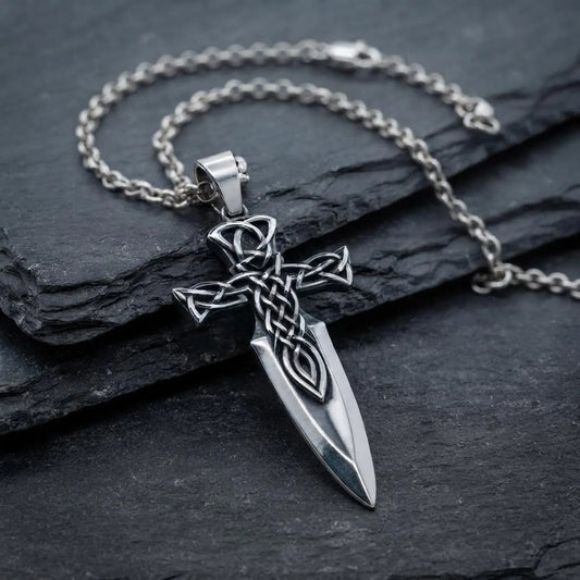 Handcrafted sterling silver Celtic Cross Sword pendant necklace featuring intricate Celtic knot engravings, inspired by medieval knights, Christian symbolism, and timeless artisan craftsmanship for men and women.