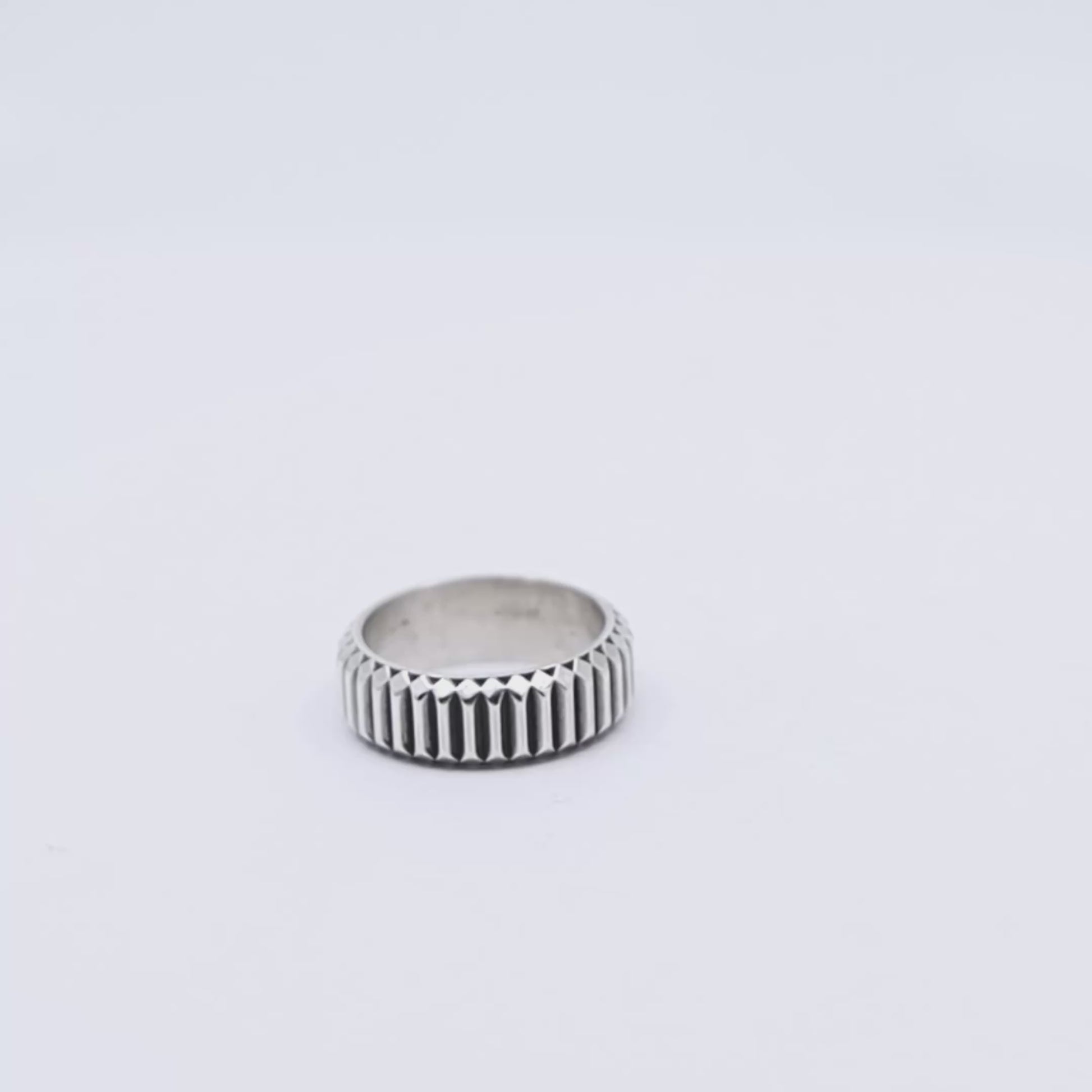 Sterling silver textured band ring for men with a modern minimalist style, highlighting hand-applied surface detailing and a sleek geometric shape, ideal as a timeless gift or wedding band alternative.
