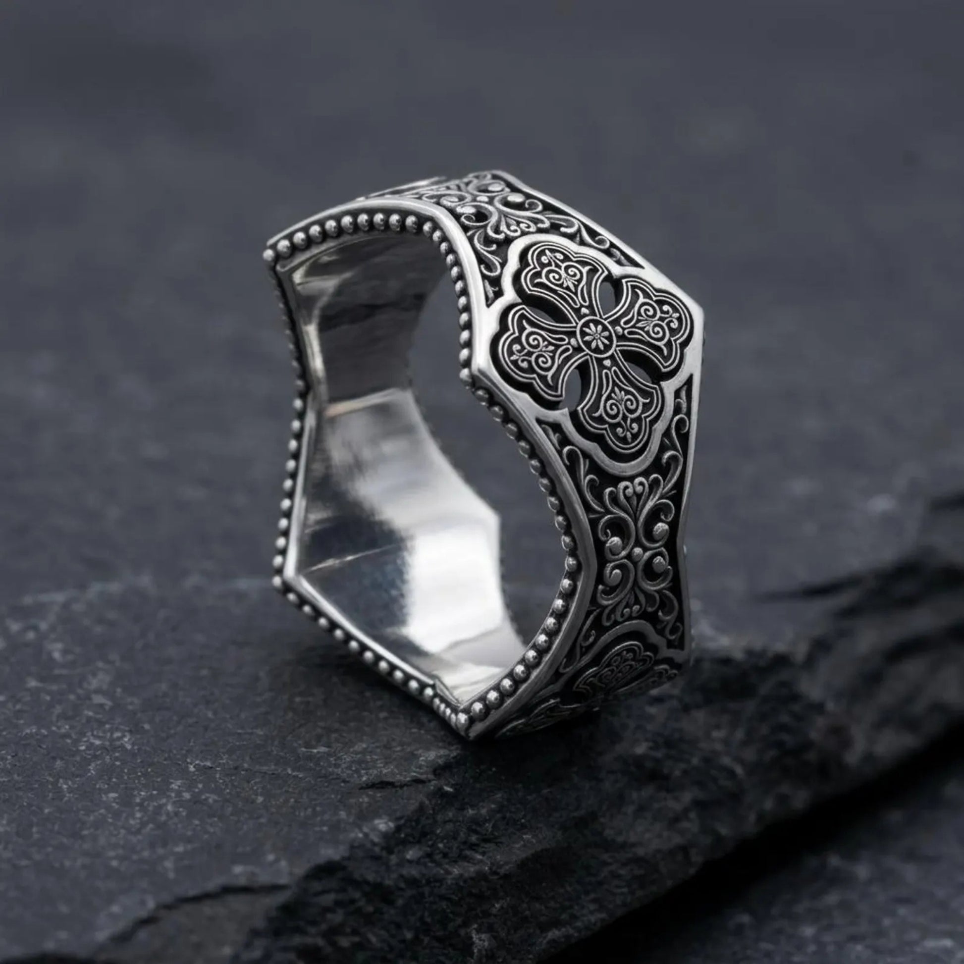Close-up view of a Gothic ornamental sterling silver ring showcasing detailed Christian cross engravings, vintage oxidized finish, and handcrafted medieval filigree craftsmanship with exceptional precision.