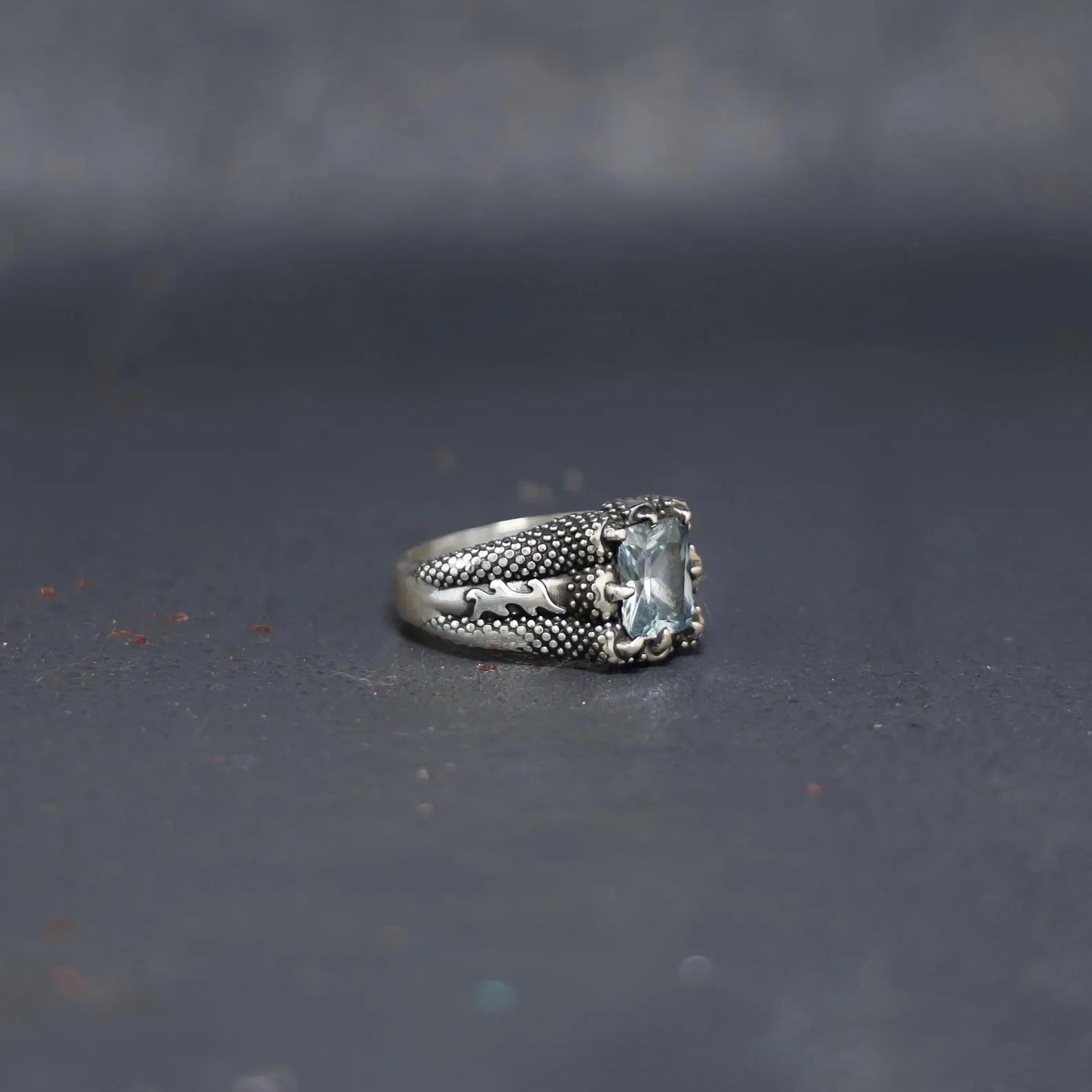 Men’s aquamarine gemstone ring with a bold sterling silver claw frame, designed to highlight the calming and protective qualities of the natural birthstone.