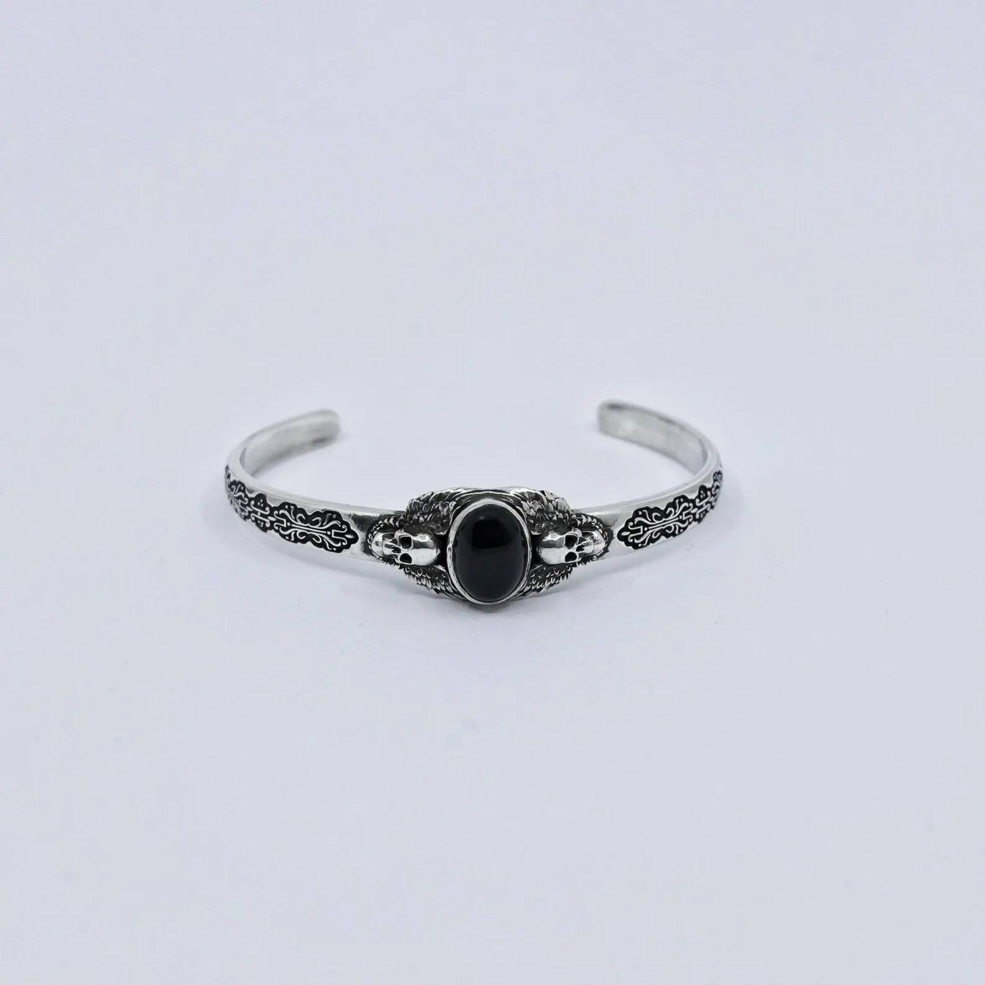 Artisan-crafted black onyx sterling silver bracelet with gothic skull details and oxidized silver texture. The design embodies dark elegance and confidence, created for modern men who appreciate handcrafted jewelry with soul.