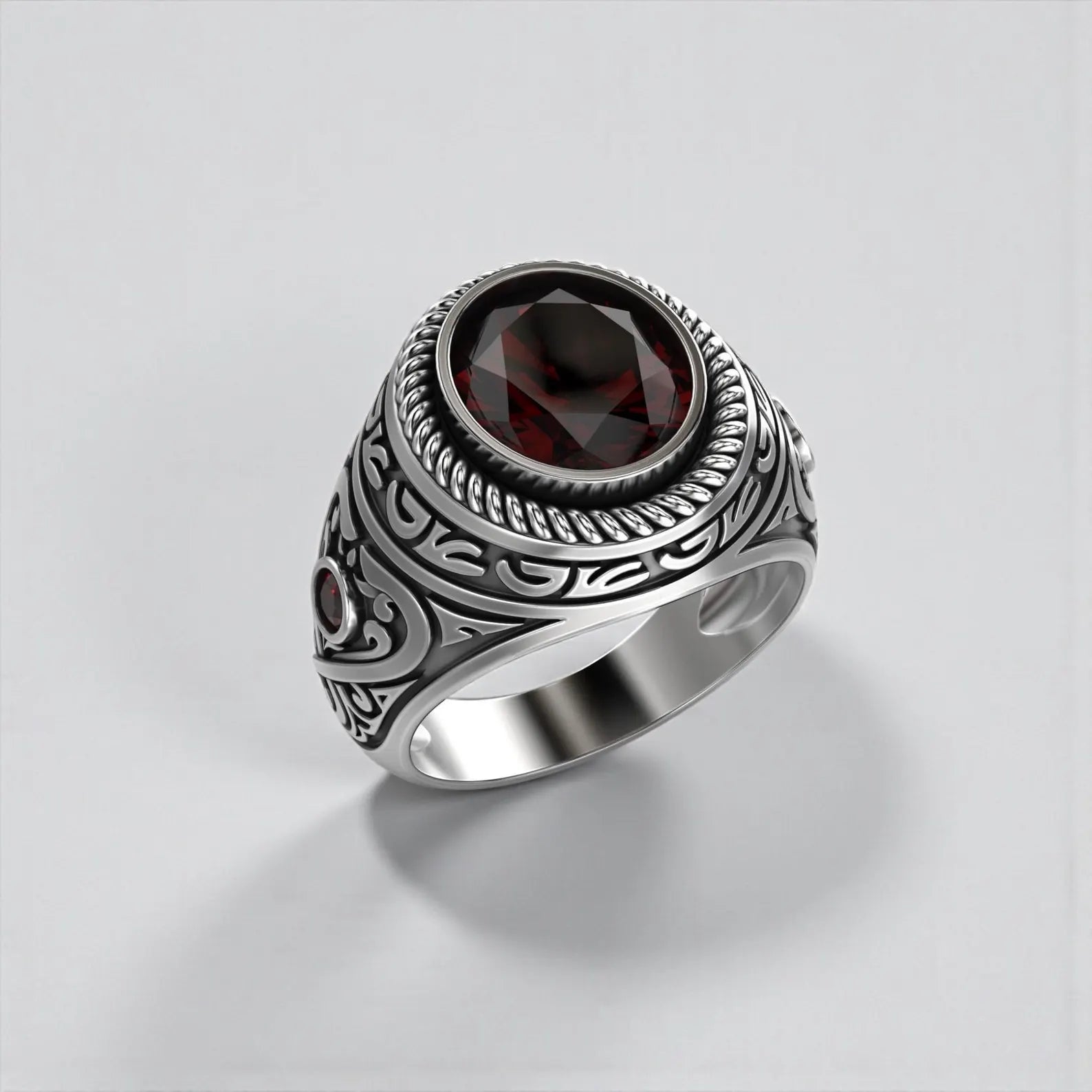 Gothic garnet ring for men showcasing a natural oval cut garnet, symbolizing passion, strength, and protection, finished with oxidized sterling silver for timeless depth