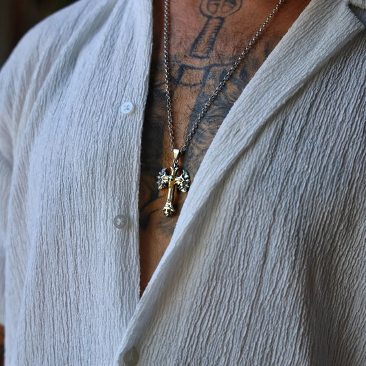 This bold gothic cross pendant necklace combines dark spirituality and medieval symbolism in a handcrafted design. Made from 925 sterling silver with gold-plated accents, the pendant features a skull and wing motif for a dramatic, timeless look. Ideal for gothic style lovers, rockers, or anyone seeking powerful, symbolic jewelry.