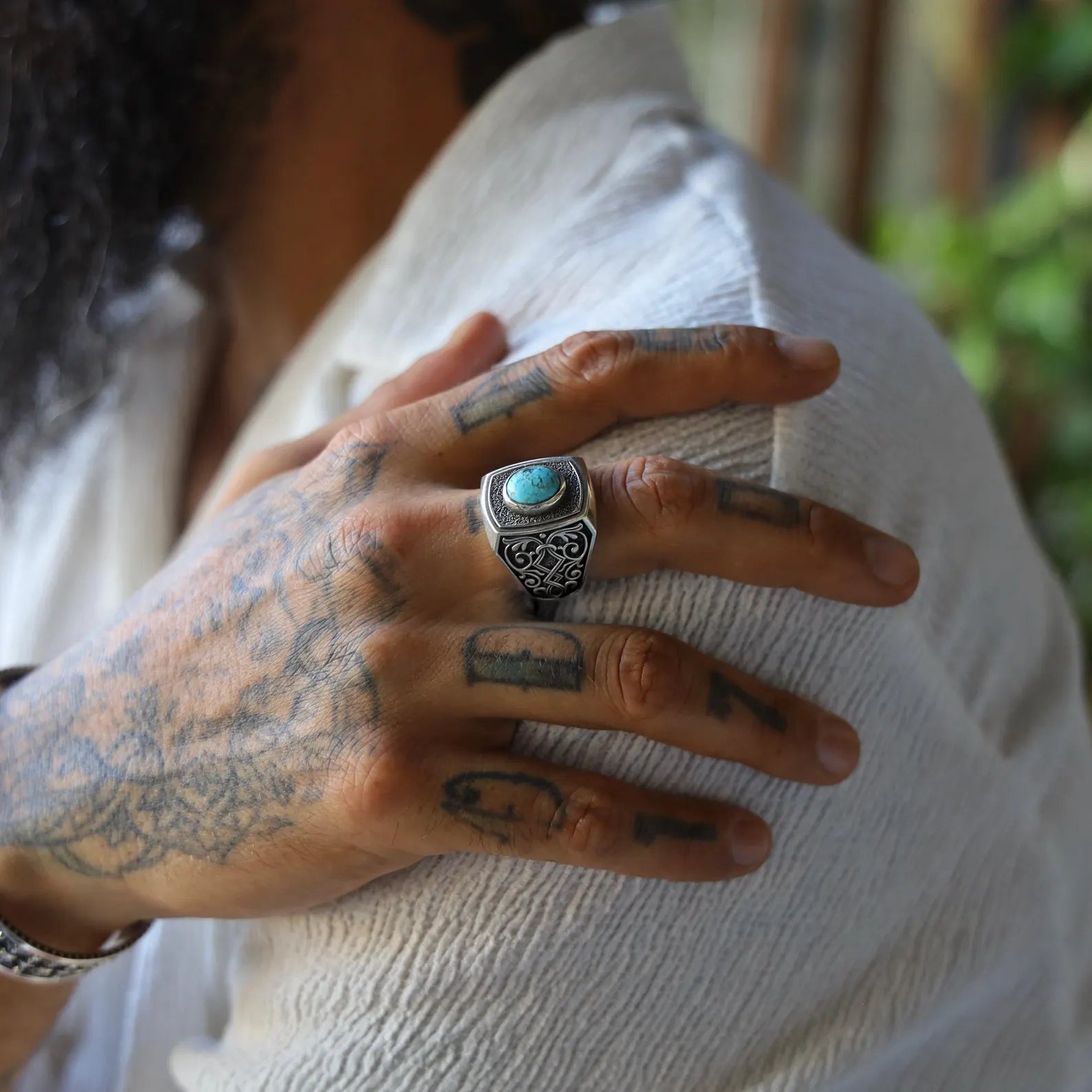 Sterling silver gothic ring for men with an oval turquoise gemstone centerpiece, handcrafted with dark oxidized details and a rugged design that blends mysticism, style, and strength.