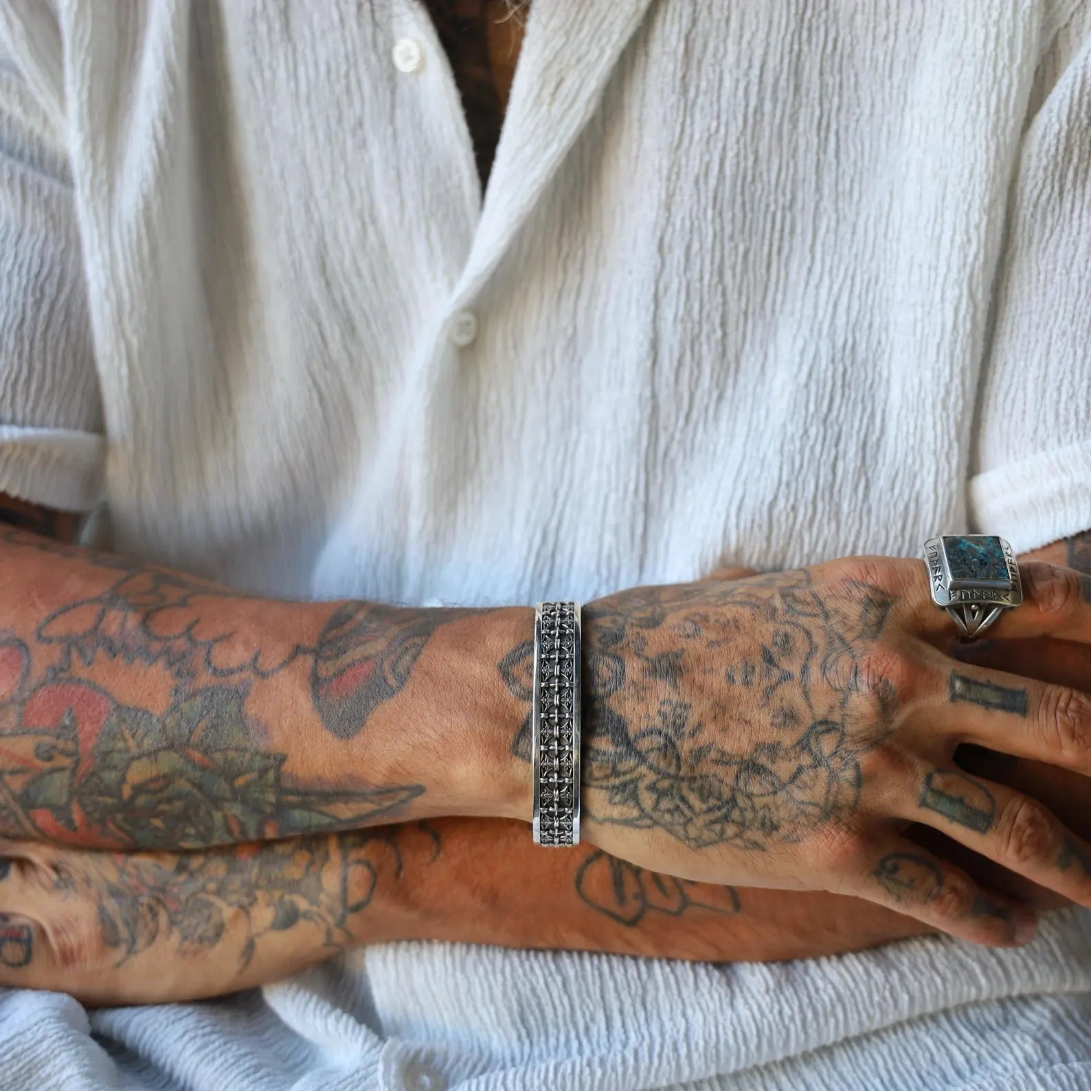 Luxury handcrafted cuff bracelet made of high-quality sterling silver, adorned with symmetrical gothic cross engravings. This adjustable men’s bracelet balances religious symbolism with a dark aesthetic, perfect for gothic fashion enthusiasts or Christian men looking for distinctive, wearable art.