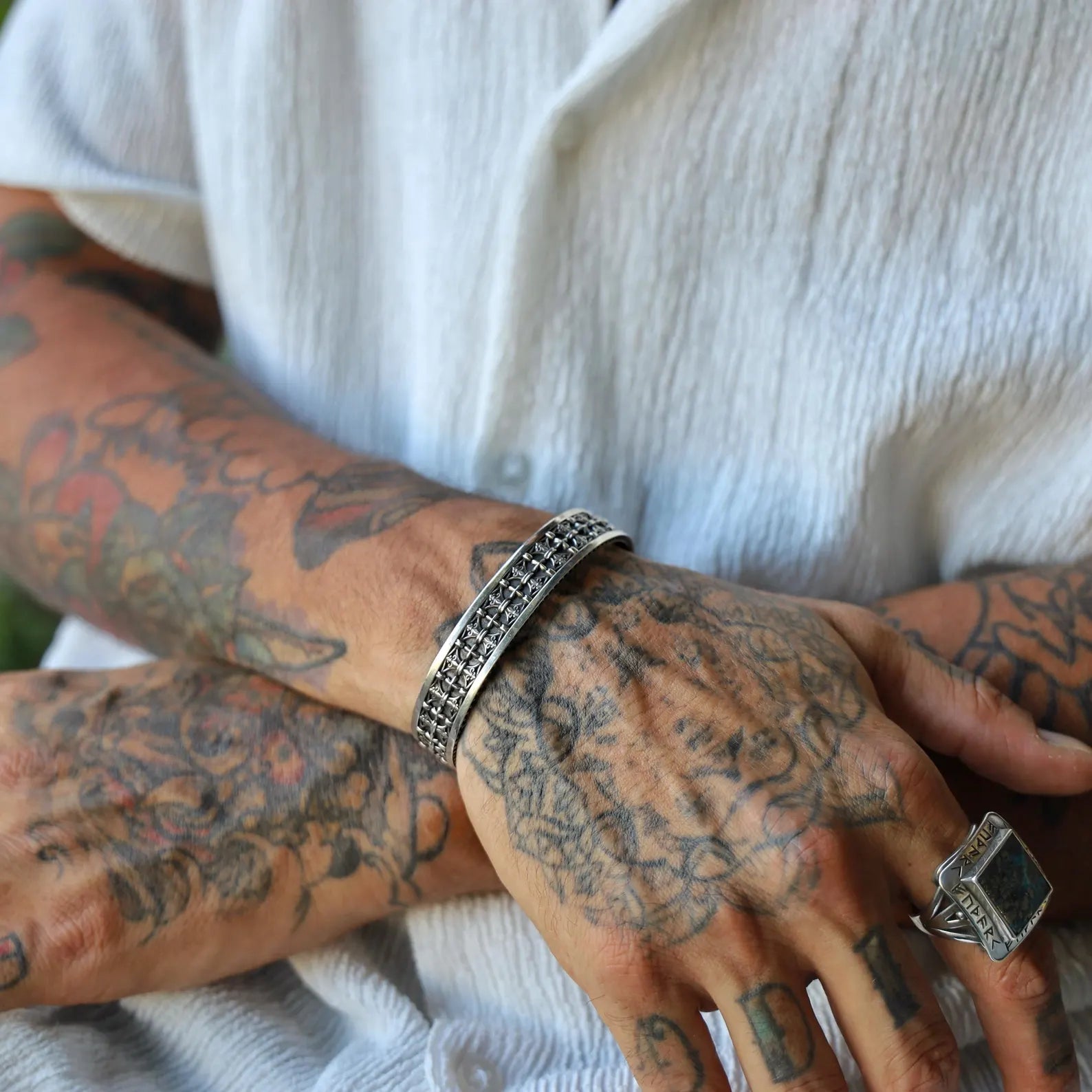 A handcrafted gothic cuff bracelet for men featuring a series of medieval cross motifs, finished in oxidized sterling silver for a rich, antique look. This bracelet is not just a fashion statement, but a representation of inner strength and belief, ideal for daily wear or special gifting occasions.