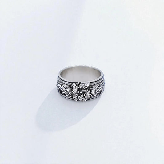 Handcrafted sterling silver Lucky 13 ring for men, featuring bold gothic typography and engraved leaf details. This biker-style band represents rebellion, luck, and individuality—ideal for rockers, tattoo lovers, or anyone with a bold spirit. Made from solid 925 silver with oxidized details for a rugged, timeless finish.
