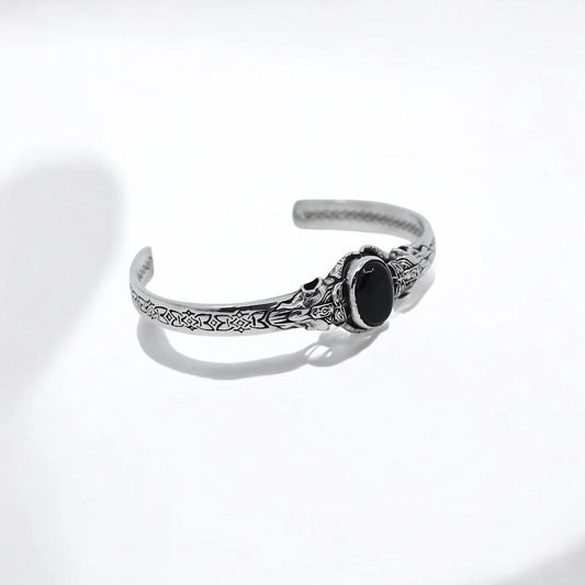 Elevate your style with this men’s silver medieval cuff bracelet, featuring a striking black onyx gemstone centerpiece that exudes a sense of mystery and ancient power. Meticulously handcrafted from high-quality sterling silver, this rugged and elegant piece captures the gothic spirit and timeless elegance of medieval jewelry. Perfect for those who appreciate bold, statement accessories with historical and spiritual significance, this bracelet is a captivating addition to any modern jewelry.