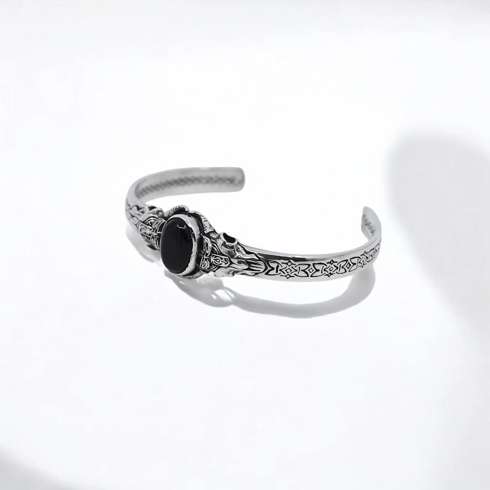 Close-up shot showcasing the expertly crafted gothic details and the striking black onyx gemstone in this handcrafted medieval cuff bracelet for men. The polished silver and oxidized finish bring an authentic medieval feel, while the bold gemstone centerpiece symbolizes strength, power, and mystery. Ideal for those who seek jewelry that combines personal symbolism and rugged elegance, this men’s silver bracelet is a wearable work of art that commands attention.