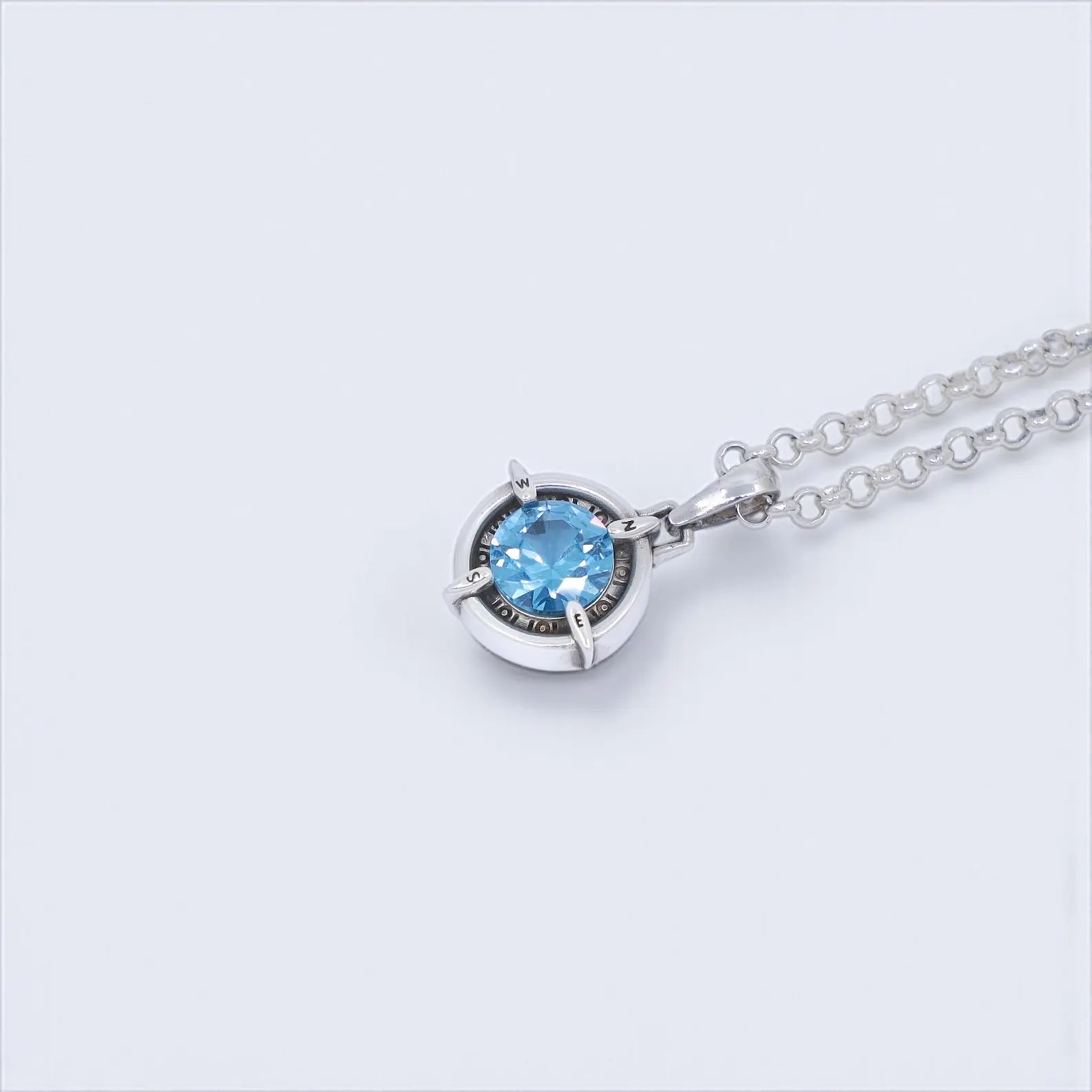 Sterling silver handmade compass pendant necklace with aquamarine gemstone, representing guidance, exploration, and inner strength. A symbolic nautical necklace perfect for both men and women. Celebrate March birthdays, anniversaries, or special occasions with this timeless gift inspired by travel, ocean spirit, and adventure.