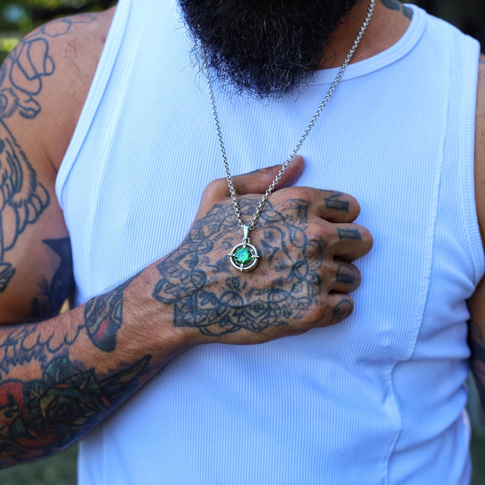 Handcrafted sterling silver compass pendant necklace featuring a vibrant emerald green gemstone. This nautical-inspired jewelry piece embodies guidance, courage, and adventure. Perfect as a meaningful gift for men and women who love to travel, explore, and embrace symbolic gemstone jewelry with timeless design.