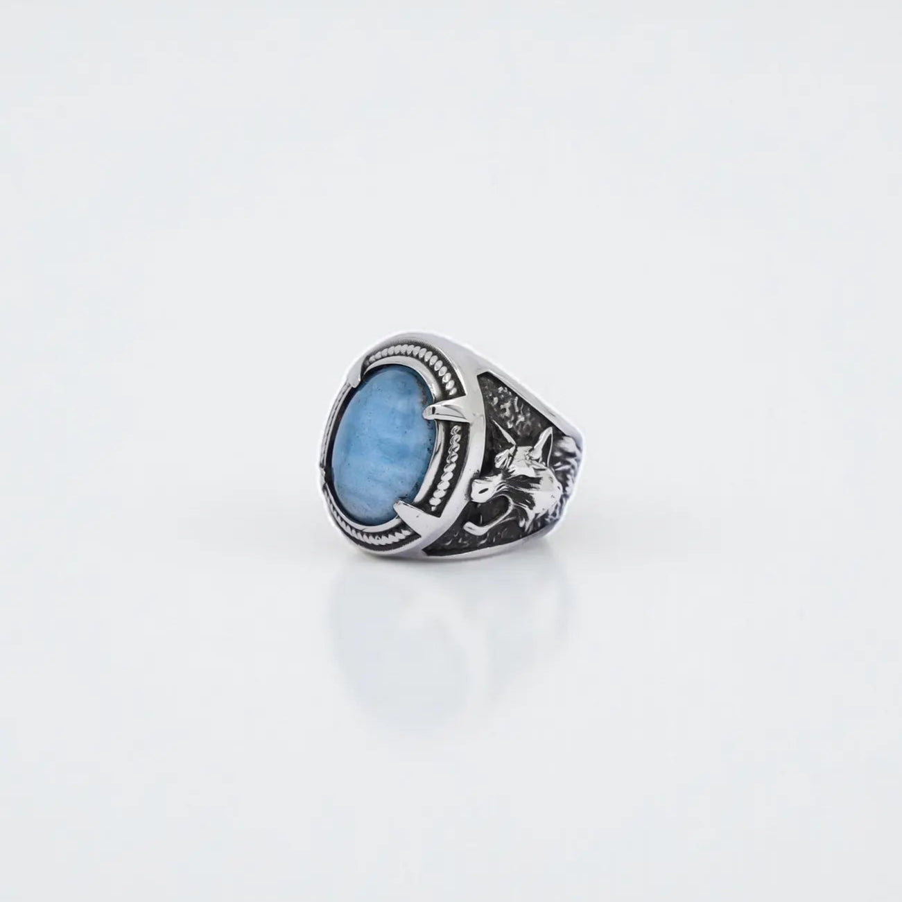 Handmade sterling silver wolf ring with natural aquamarine gemstone, designed in Viking and Norse mythology style. This men’s jewelry piece combines strength, protection, and elegance with detailed wolf engravings and polished aquamarine stone. Perfect as a gift for him, a Viking warrior accessory, or a unique handcrafted silver statement ring.
