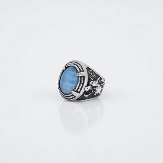 Handmade sterling silver wolf ring with natural aquamarine gemstone, designed in Viking and Norse mythology style. This men’s jewelry piece combines strength, protection, and elegance with detailed wolf engravings and polished aquamarine stone. Perfect as a gift for him, a Viking warrior accessory, or a unique handcrafted silver statement ring.