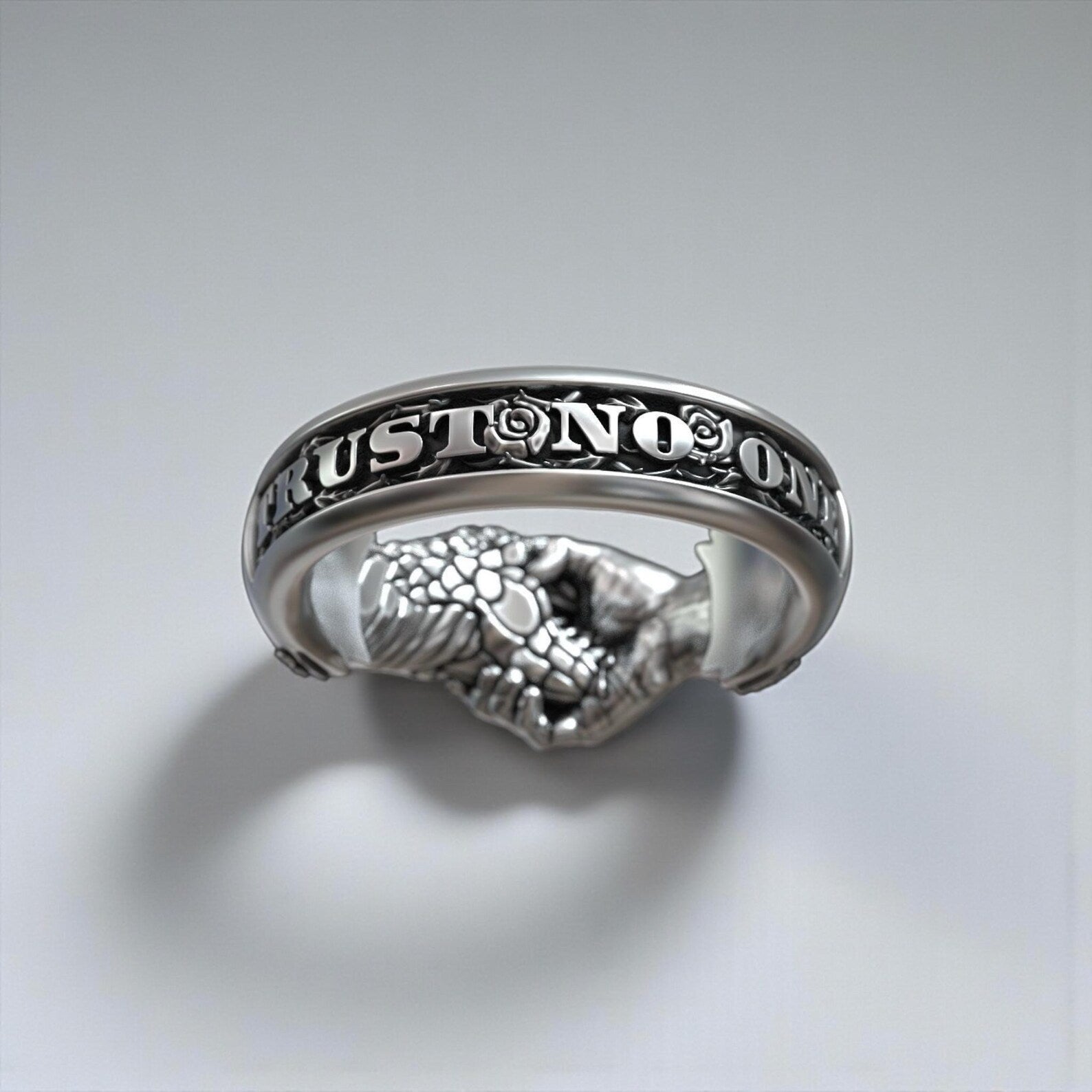 Close-up macro shot of a handmade gothic serpent ring with handshake motif, crafted in sterling silver with detailed texture and dark fantasy aesthetic for men who love unique jewelry