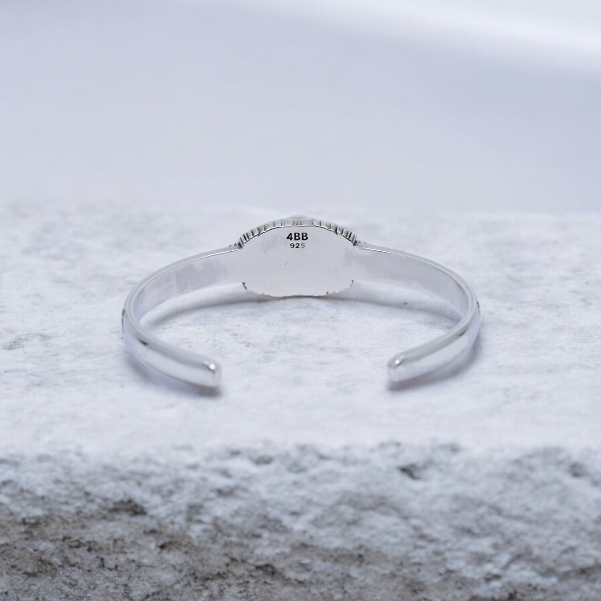 High-quality photo of a black onyx silver cuff bracelet, handmade with gothic skull details. Perfectly balanced between rugged and refined, this bracelet expresses strength and individuality for confident modern men.