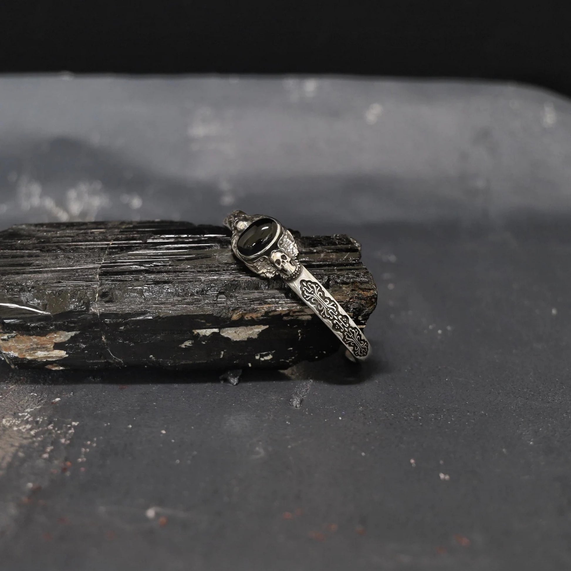 Luxury sterling silver skull bracelet with onyx stone, handcrafted to perfection. Each detail, from the oxidized textures to the polished gemstone, reflects premium artistry — ideal for collectors of dark silver men’s jewelry.