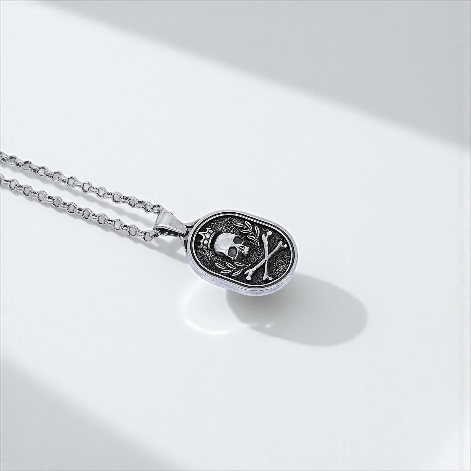 Handmade biker necklace with a gothic skull pendant, showcasing intricate sterling silver craftsmanship with crown and crossbones detailing, ideal for men who embrace bold alternative fashion.