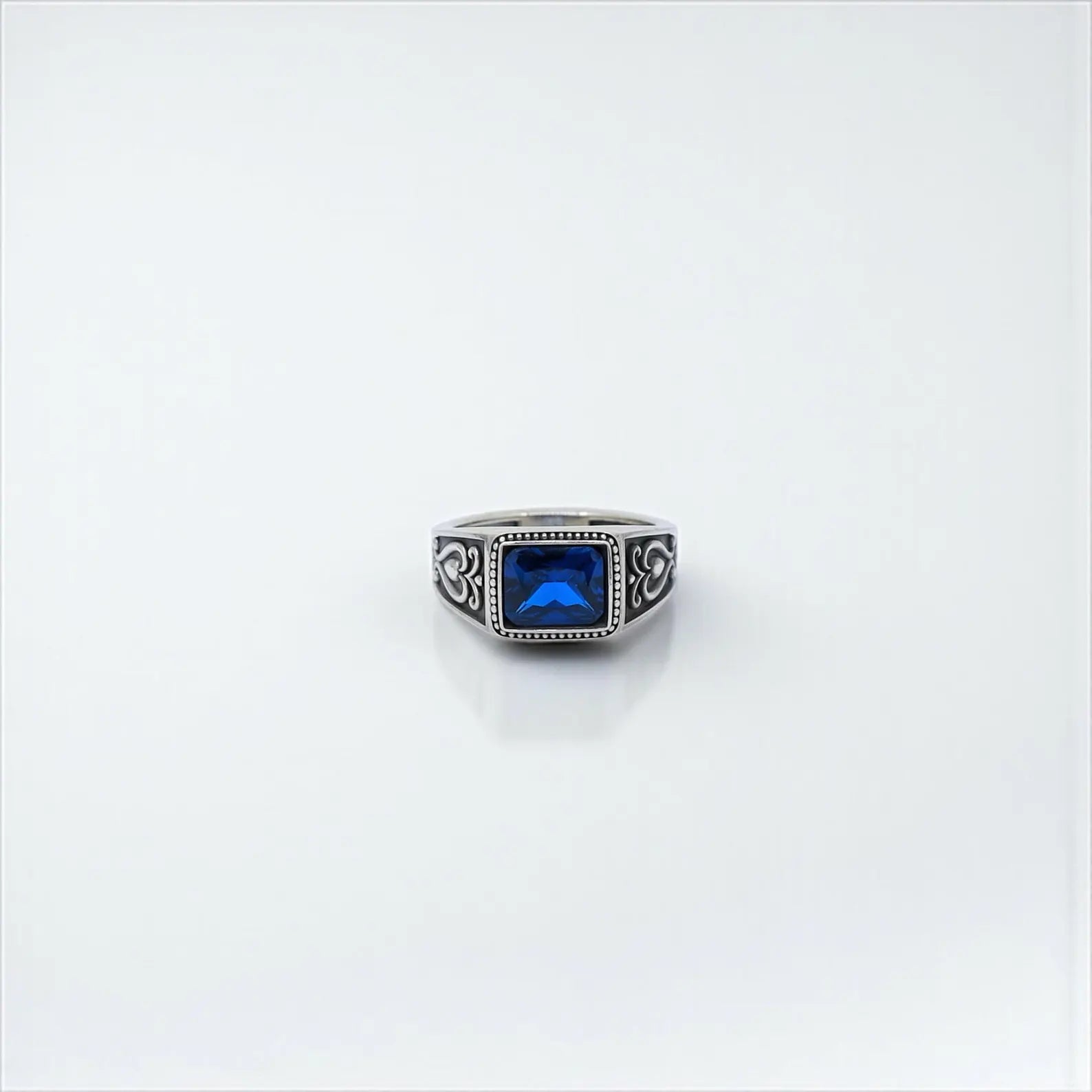 Elegant mens silver ring with a deep blue zircon stone cut in emerald style, set in a detailed gothic band – perfect for anniversaries, birthdays, or meaningful personalized gifts.