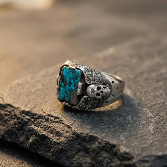 Mens sterling silver skull ring with natural turquoise gemstone and oxidized gothic detailing in handcrafted biker jewelry style